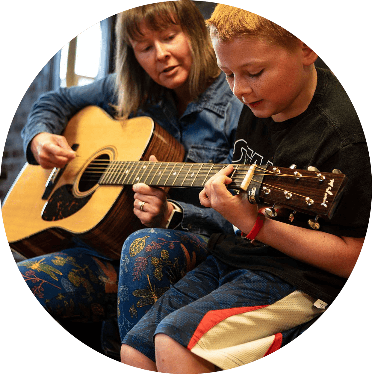 Young boy learning the guitar